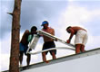 Picture of three guys installing PV.