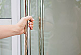 Glass door being pulled open by woman's arm