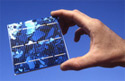 Picture of hand holding photovoltaic cell.