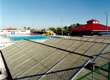 Picture of a community pool with a solar hot water system.