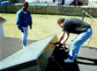 Picture of two FSEC employees installing a solar hot water collector on a roof.
