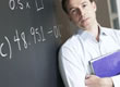 Picture of a teacher at a blackboard.