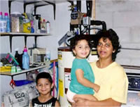Picture of a SWAP family near their hot water storage tank.