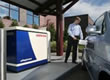 Picture of a man filling a hydrogen powered car at a hydrogen pump.