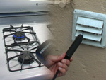 photo: gas stove ignited with CO probe over flame and CO probe in outside dryer vent