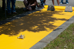 Photograph of official timing the pink Race Girls model fuel-cell car.