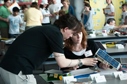 Photograph of Krissy Schroen holding a JSS model car.