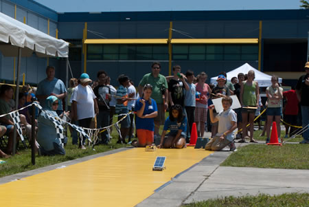 Photograph of two solar model cars racing.