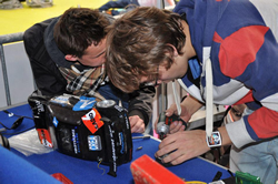 Photo of students fixing their car.