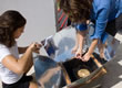 Picture of a teacher and a student using a solar cooker.