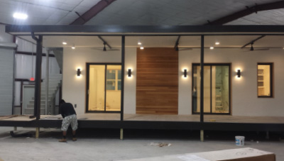 A worker adding finishing touches to a Pearl Homes cottage.