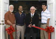 Hassett cutting ribbon.