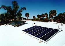 Photo: White metal roof with solar water heating and solar electricity panels.