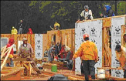 Photo of workers building a house.
