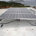 photo of photovoltaic array with ocean in the background.