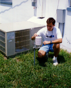 FSEC research engineer, Jeff Sonne, adjusts a pyranometer leveling base on the apparatus used in the measurement of condenser air and insolation conditions at site 2