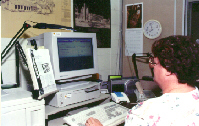 Photo of a man at a computer.