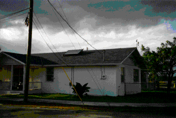 photo of a house with a solar collector on the roof.