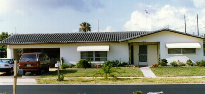 Photo of house with dark roof.