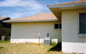 Photo of the outside of a stucco house.