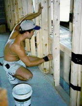 Man working on house.