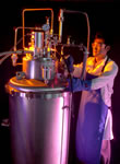 Picture of researcher J. Baik with a cryocooler.