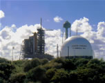 Picture of Hydrogen Tank with the Space Shuttle in the background.