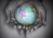 Picture of a globe held in hands.