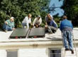 Picture of a group being trained on roof installation of a solar thermal collector by FSEC staff.