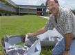 Picture of John Harrison with a solar cooker.