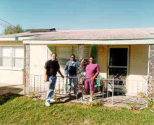 Picture of a SWAP family on the porch of their house.