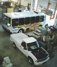 Picture of an electric bus and hybrid pickup truck.